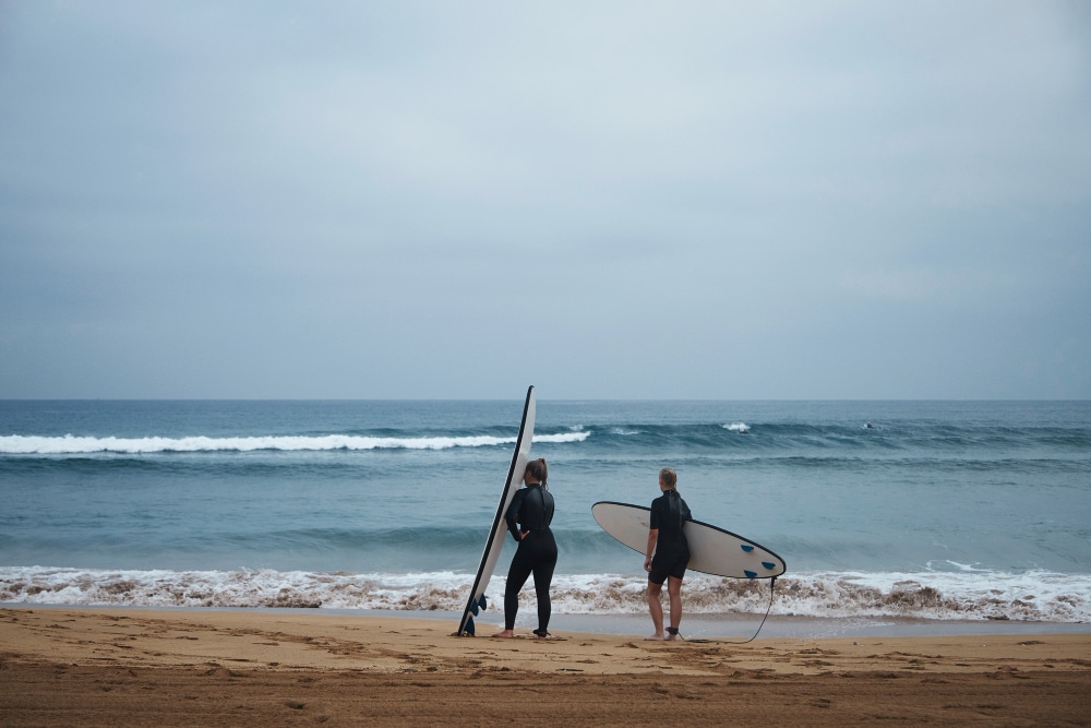 Image of two girls with surfboards