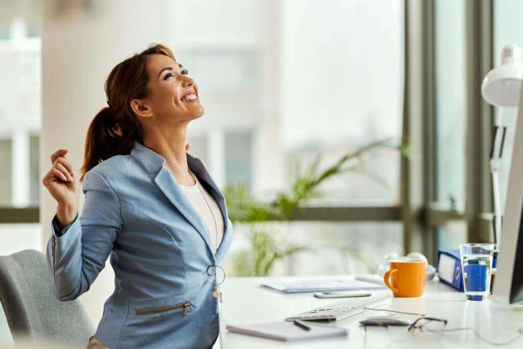 Image for a female entrepreneur looking up and stretching