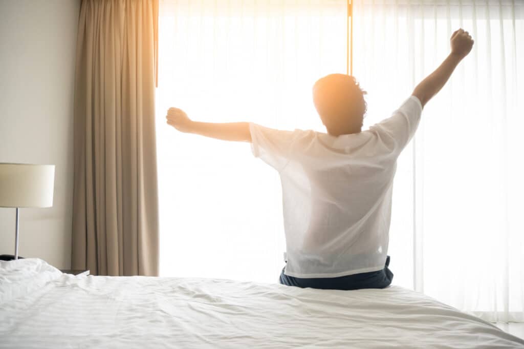 Image of a man waking up from the sleep 